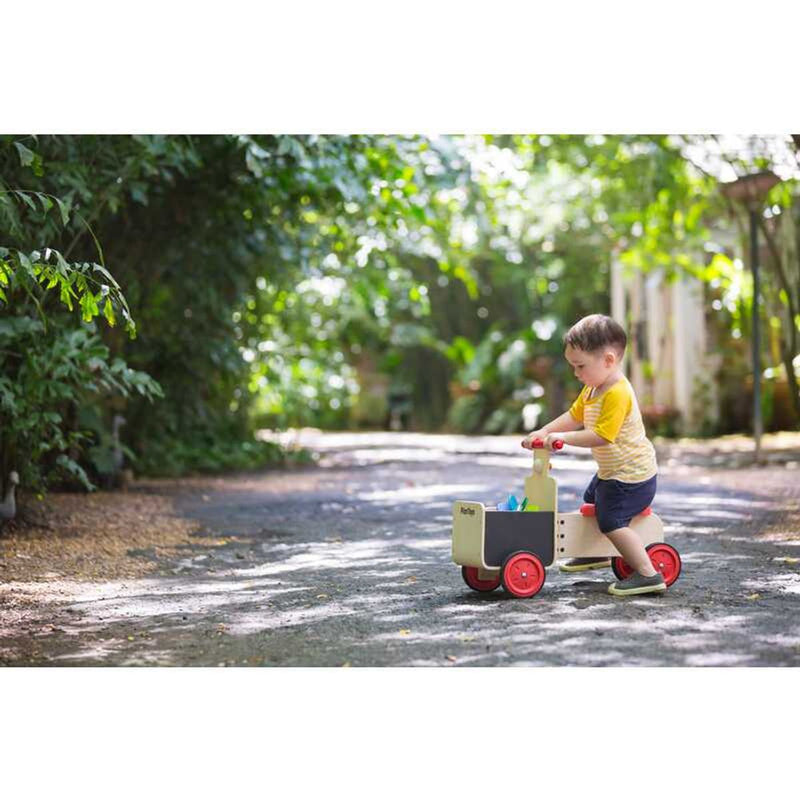 Kid playing PlanToys Delivery Bike