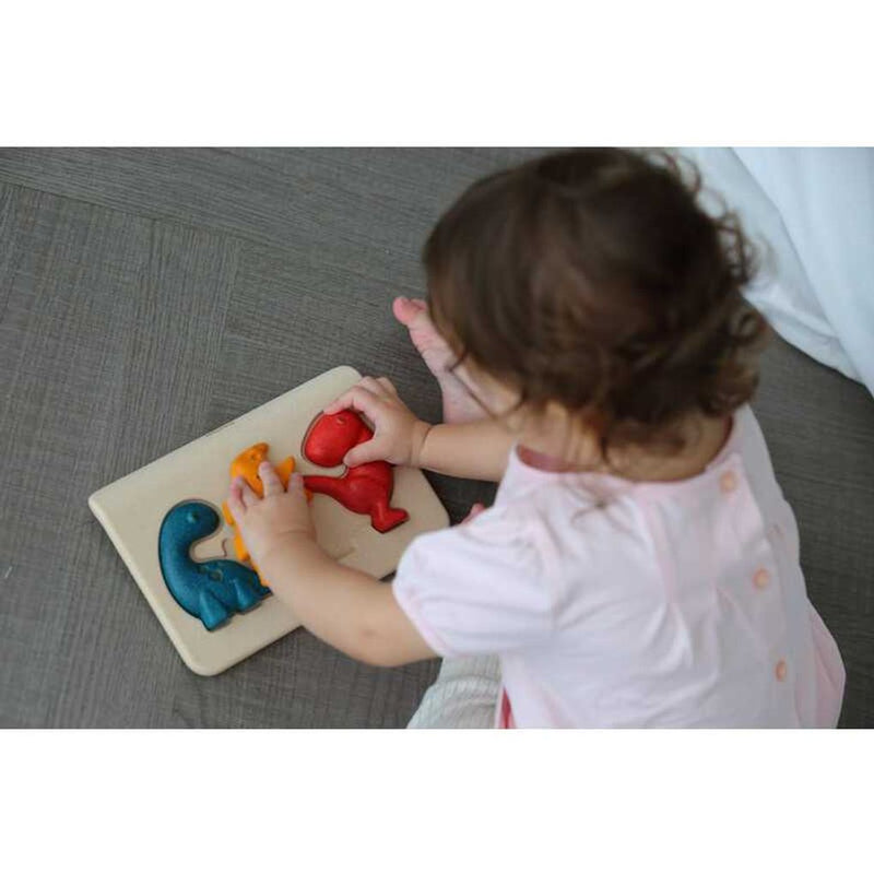 Kid playing PlanToys Dino Puzzle