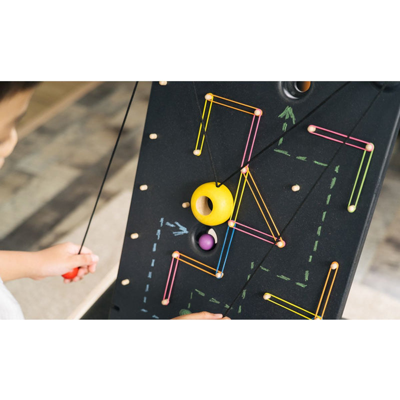 Kid playing PlanToys Wall Ball Game