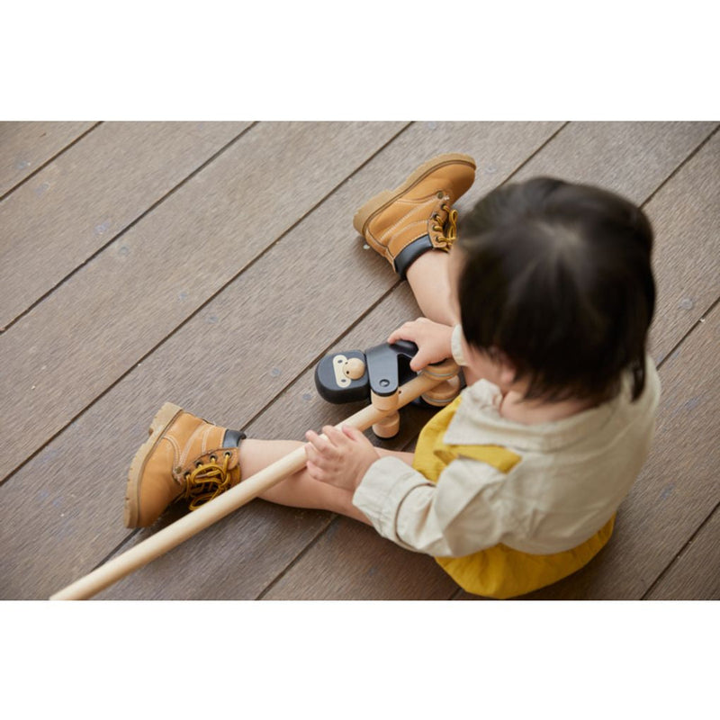 Kid playing PlanToys Climbing Gorilla