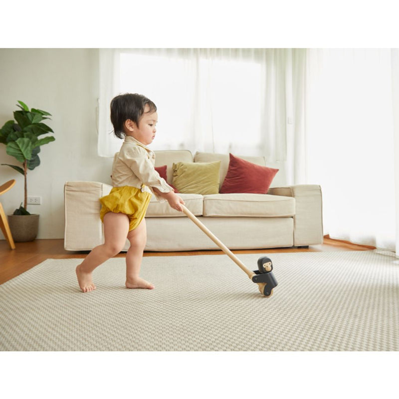 Kid playing PlanToys Climbing Gorilla