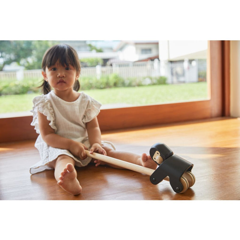 Kid playing PlanToys Climbing Gorilla