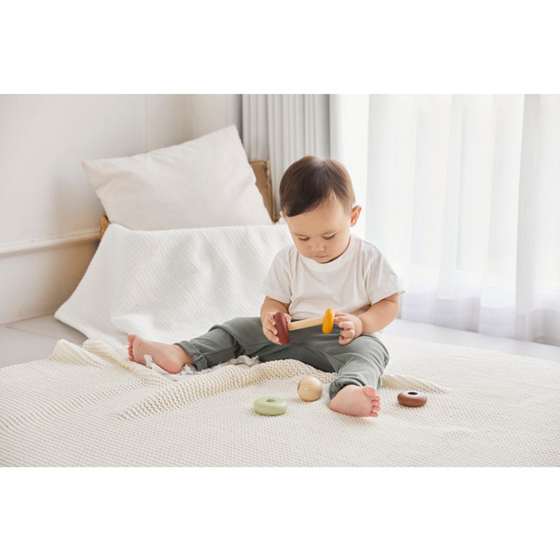 Kid playing PlanToys My First Stacking - Modern Rustic