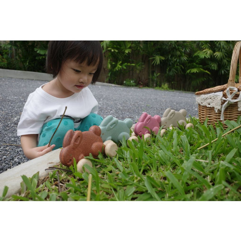 Kid playing PlanToys Push Along Bunny - Pink