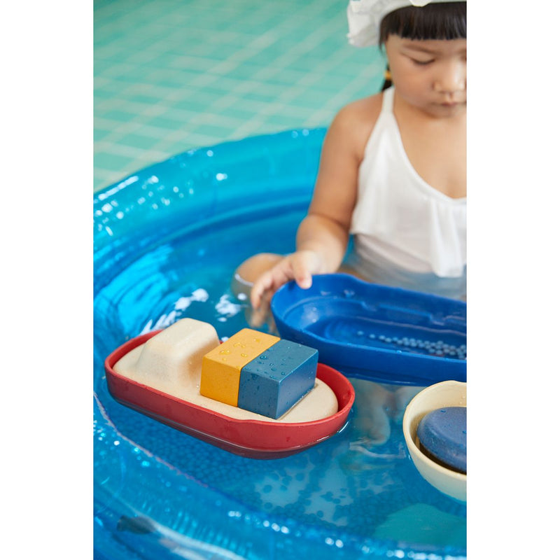 Kid playing PlanToys Cargo Ship