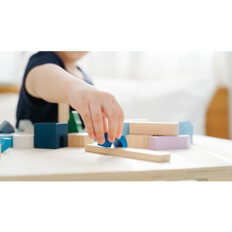 Kid playing PlanToys Urban City Blocks