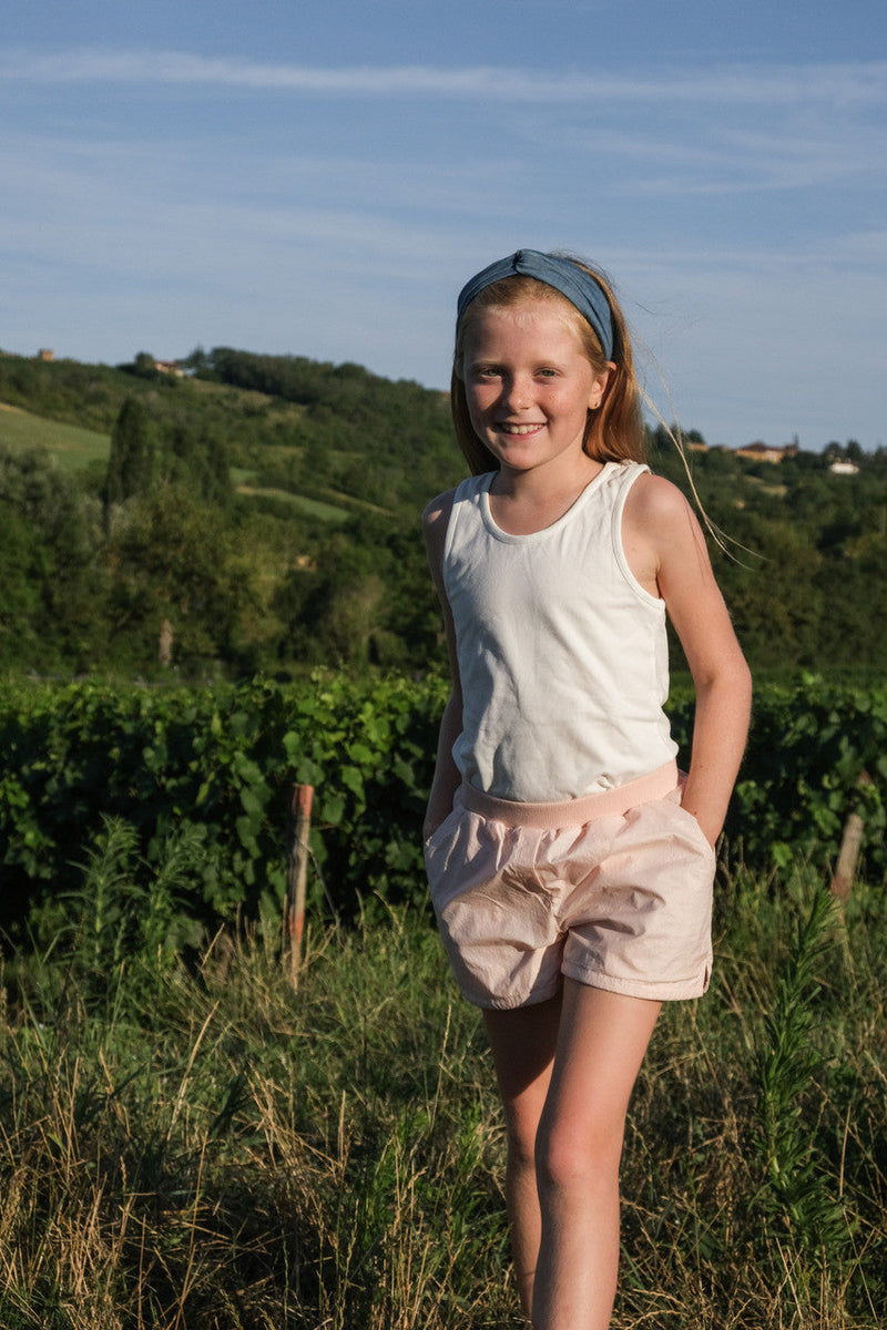 Little Hedonist organic cotton shorts with side pockets and splits for boys and girls in Evening Sand