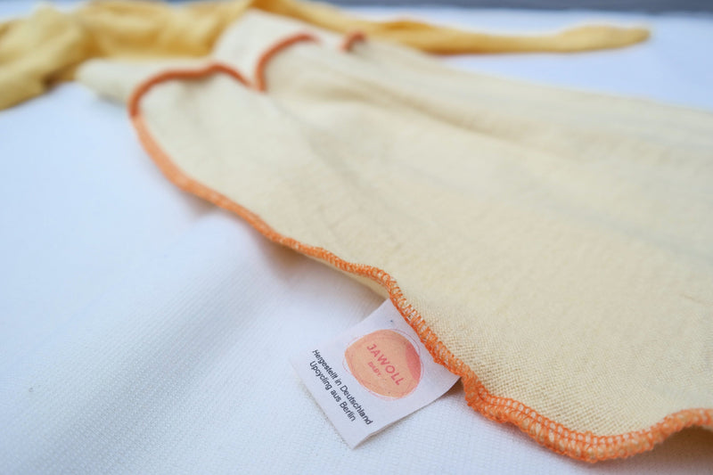 Lightweight summer romper sleeping bag for babies 0-6 months made from upcycled wool in pastel yellow