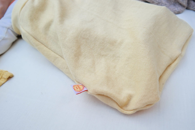 Lightweight summer romper sleeping bag for babies 0-6 months made from upcycled wool in pastel yellow